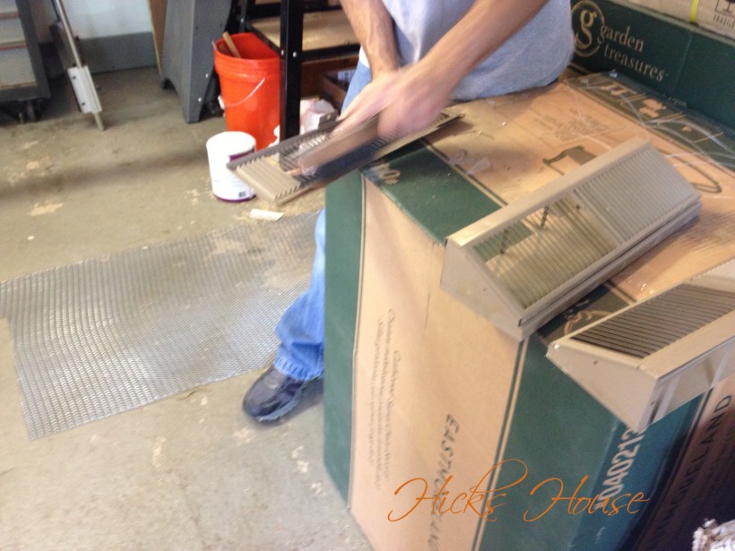 scrubbing the vent with a wire brush